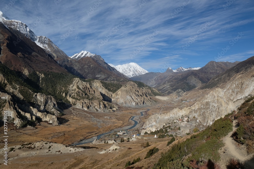 View of Annapurna range, Manang Valley and village Bhraka (Braga) with Gompa - Buddhist monastery in Himalaya, Nepal. During trekking around Annapurna - Annapurna Circuit trail View of Annapurna range, Manang Valley and village Bhraka (Braga) with Gompa - Buddhist monastery in Himalaya, Nepal. During trekking around Annapurna - Annapurna Circuit trail