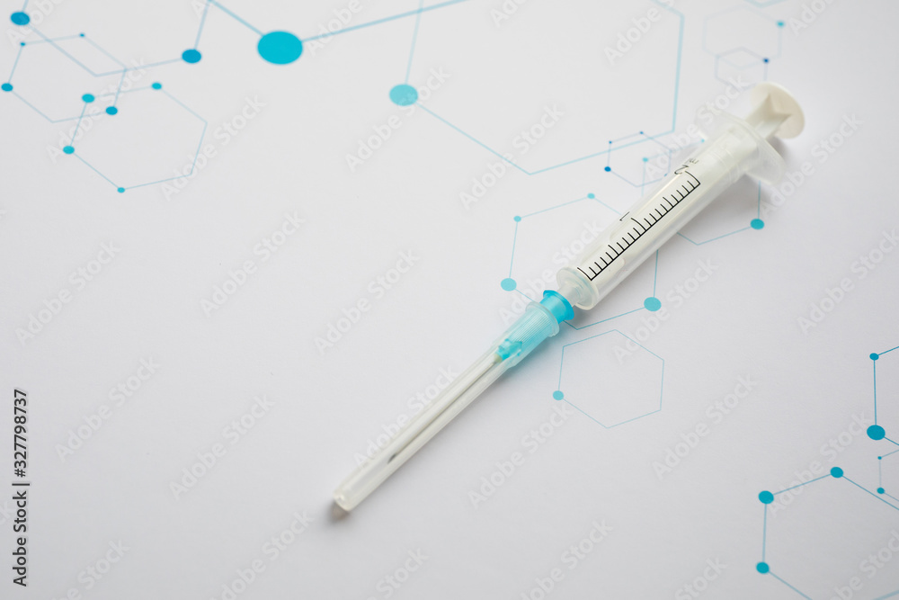 Medical syringe on the science background Medical syringe on the science background