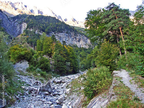 A seasonal torrential stream under the Ratikon border alpine mountain massif or Raetikon Grenzmassiv, Fläsch (Flasch or Flaesch) - Canton of Grisons (Graubünden or Graubuenden), Switzerland photo