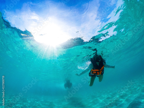 woman wearing snorkeling mask diviing under clear sea water  © stockphoto mania