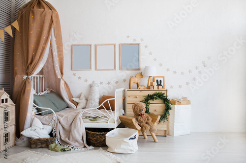Plakat Stylish scandinavian baby room with crib, dresser, wooden toys and lamp. zero waste. eco-friendly materials