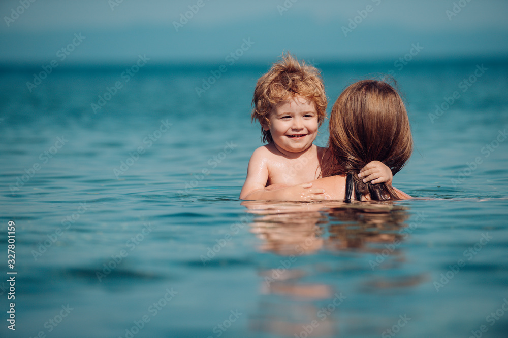 Happy summer mood. Son with mother in the sea. Family vacation in Greece.