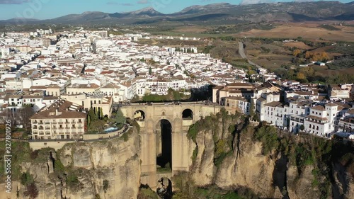 Town of Ronda Spain in the province of Málaga with Puente Nuevo arch bridge joining the village, Aerial pan right circling shot