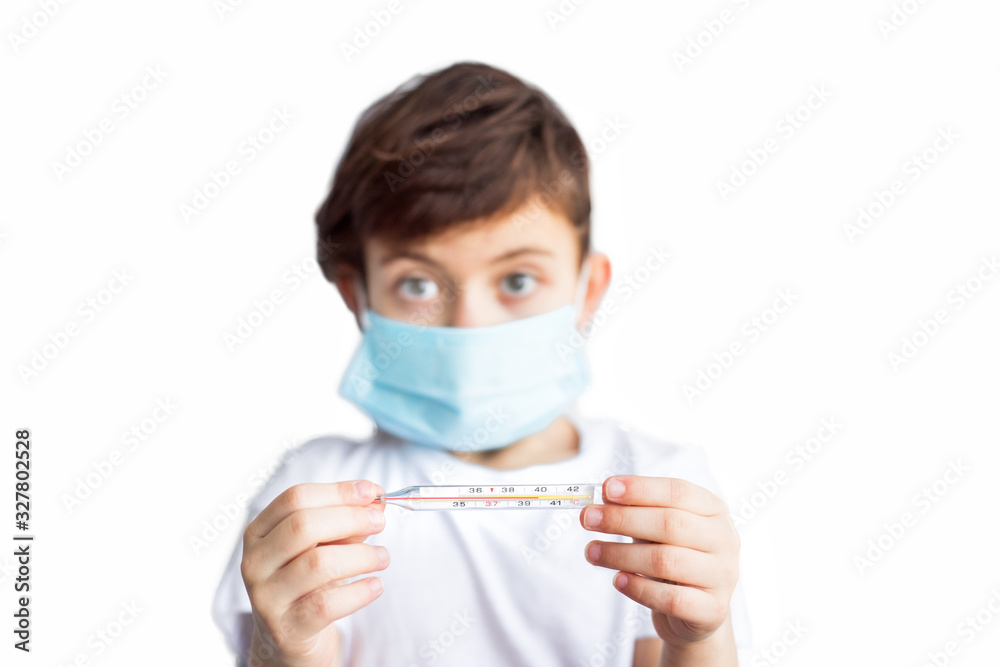 Isolated on white portrait of blurred child face in medical mask with spirit thermometer with high temperature on it in hands. Worldwide epidemy of coronavirus covid-2019. Health care. Insurance Isolated on white portrait of blurred child face in medical mask with spirit thermometer with high temperature on it in hands. Worldwide epidemy of coronavirus covid-2019. Health care. Insurance