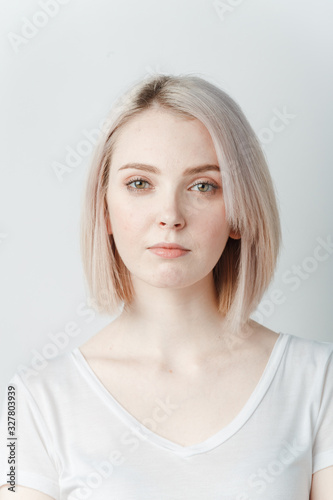 Indoor portrait of beautiful blonde young woman