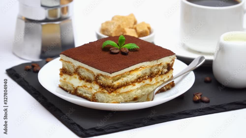 Tiramisu dessert portion, mocha coffee maker, milk or cream, sugar and cup of fresh espresso coffee Tiramisu dessert portion, mocha coffee maker, milk or cream, sugar and cup of fresh espresso coffee