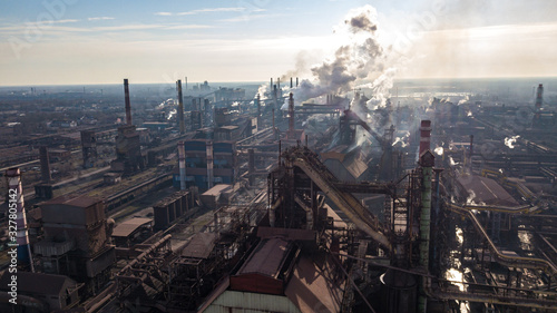 Steel ecology metallurgical iron plant smokes from pollution of industry pipes. View from the drone. © Андрей Трубицын