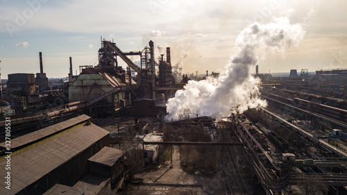 Steel ecology metallurgical iron plant smokes from pollution of industry pipes. View from the drone.