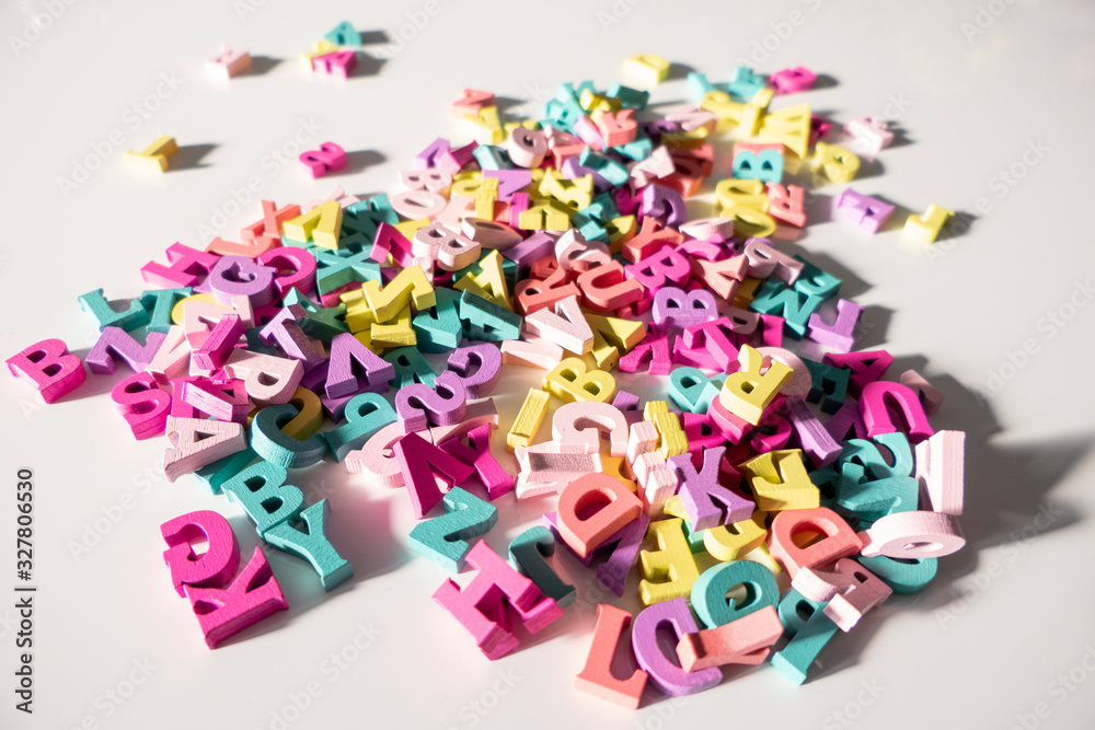 Plenty of colorful wooden letters on a White background Plenty of colorful wooden letters on a White background