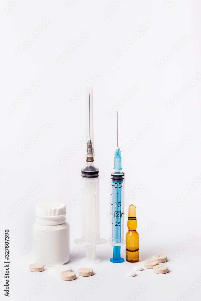 Medicaments on a white background. Syringe, pills, injection and other drugs to cure people and support health. Medicines and tablets against diseases and viruses. Medicaments on a white background. Syringe, pills, injection and other drugs to cure people and support health. Medicines and tablets against diseases and viruses.