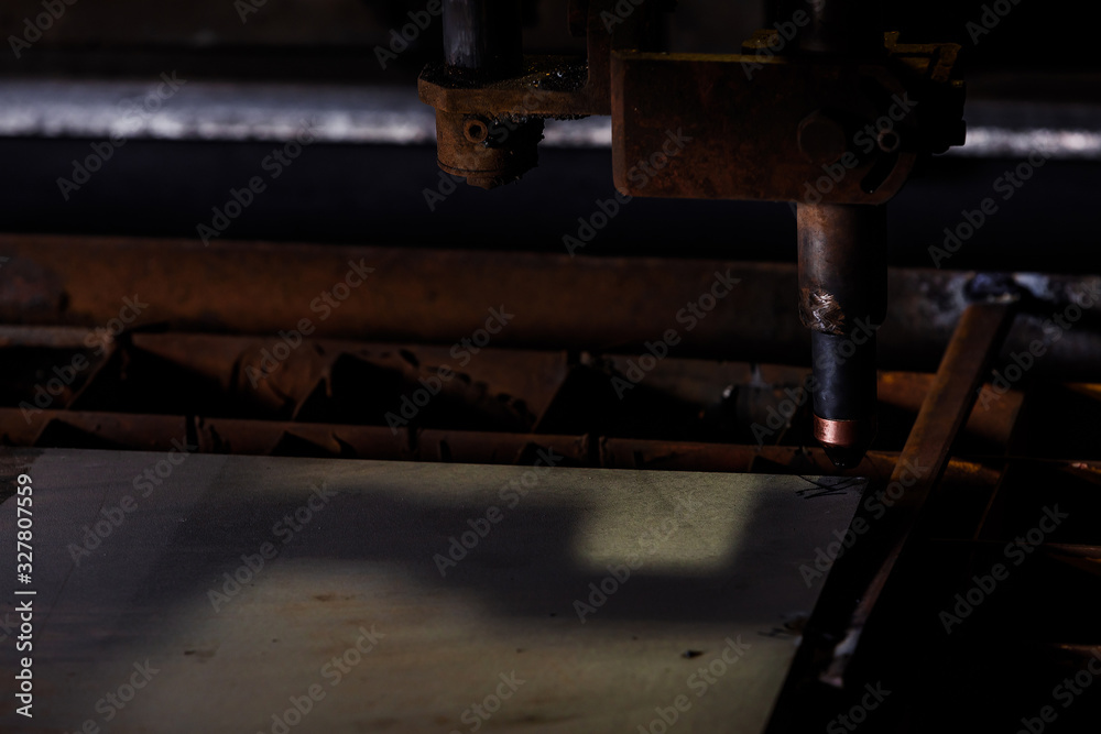Plasma cutting of metal with a cnc. Plasma cutting machine cutting steel sheet.Industrial metal cutting by plasma laser Plasma cutting of metal with a cnc. Plasma cutting machine cutting steel sheet.Industrial metal cutting by plasma laser