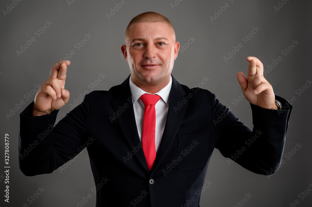 Businessman dressed in suit showing double good luck Businessman dressed in suit showing double good luck