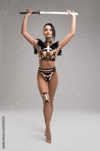 Obraz na plátne Slim female warrior in stylish metal underwear