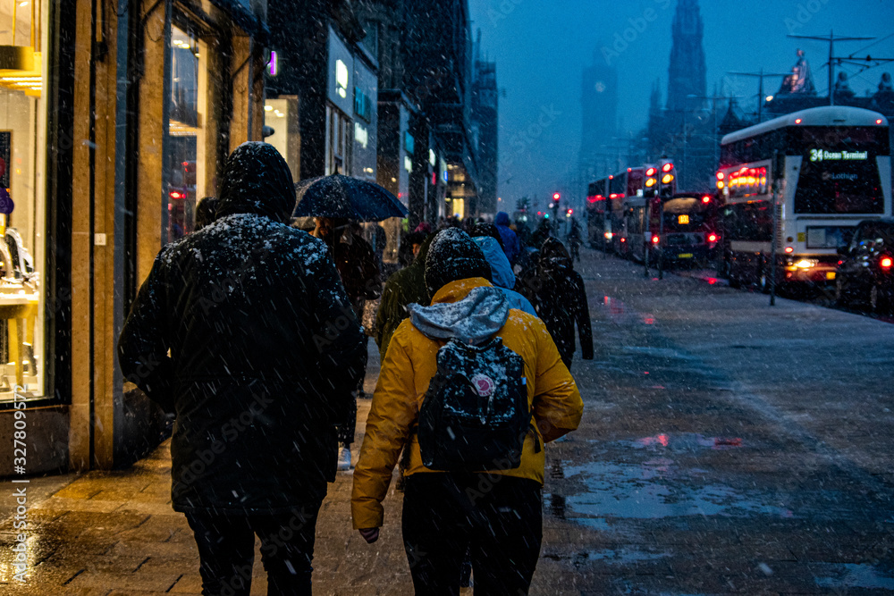 People walking in Princes Street during a snow in Edinburgh, UK. People walking in Princes Street during a snow in Edinburgh, UK.