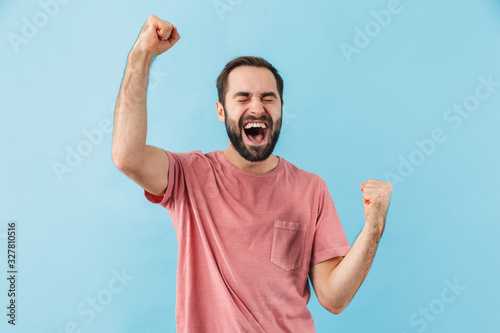 Excited surprised man make winner gesture.