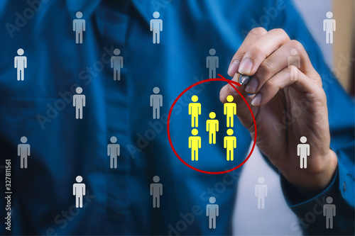 Teamwork or focus niche marketing concept. A businessman write a red line circle around yellow businessman icon.