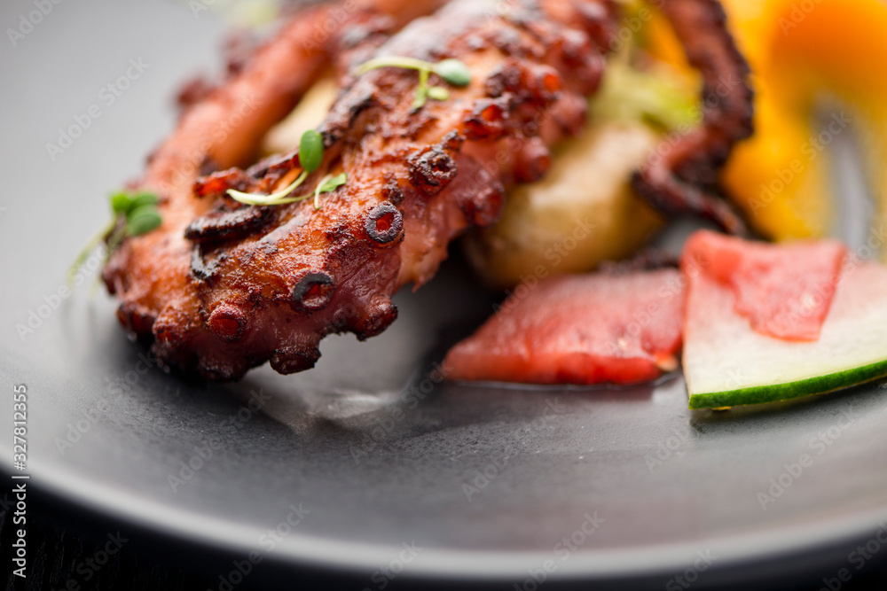 Octopus. Fresh caught octopus, seasoned with salt & pepper & grilled w/ olive oil and lemon juice. Served w/ a green leaf salad, heirloom tomatoes, red onions and Kalamata olives. Octopus. Fresh caught octopus, seasoned with salt & pepper & grilled w/ olive oil and lemon juice. Served w/ a green leaf salad, heirloom tomatoes, red onions and Kalamata olives.