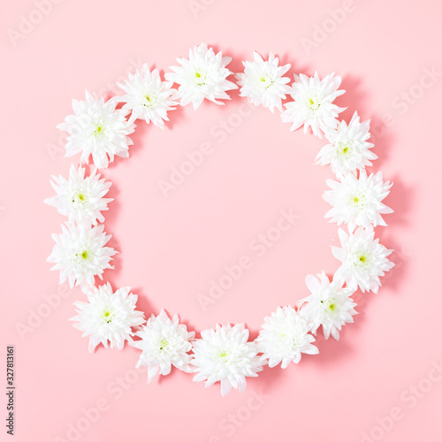 Beautiful flowers composition. Wreath made of white flowers on pastel pink background. Flat lay, top view, copy space, square