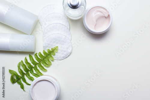 Facial cleansing products and containers with face creams and cotton wool pads