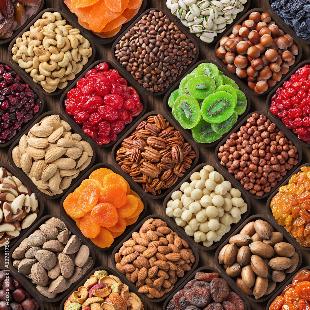 assorted nuts and dried fruits. mix snacks in wooden bowls, food background. assorted nuts and dried fruits. mix snacks in wooden bowls, food background.