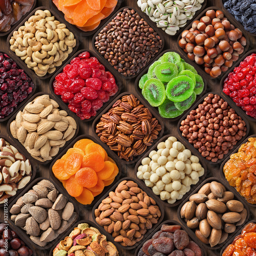 Fototapeta Naklejka Na Ścianę i Meble -  assorted nuts and dried fruits. mix snacks in wooden bowls, food background.