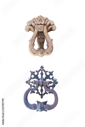 two old metal door handle with a beautiful metal ornament isolated on a white background