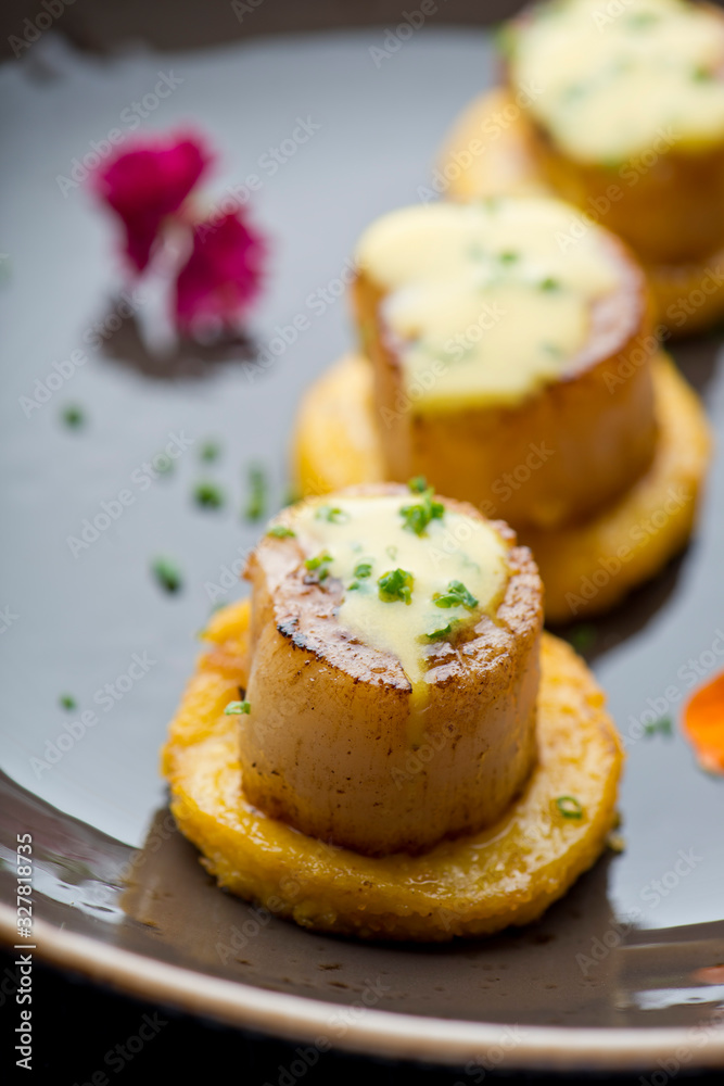Scallops. Sea Scallops seared in brown butter sauce and garnished with a lemon sauce. Scallops. Sea Scallops seared in brown butter sauce and garnished with a lemon sauce.