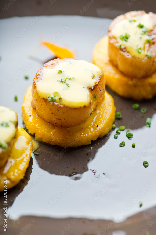 Scallops. Sea Scallops seared in brown butter sauce and garnished with a lemon sauce. Scallops. Sea Scallops seared in brown butter sauce and garnished with a lemon sauce.