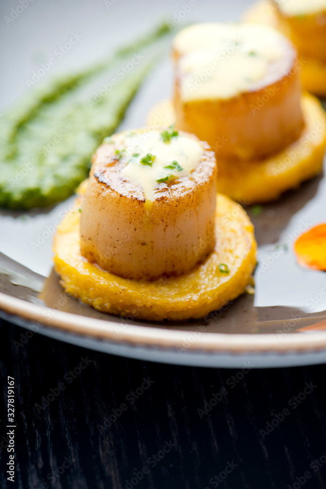 Scallops. Sea Scallops seared in brown butter sauce and garnished with a lemon sauce. Scallops. Sea Scallops seared in brown butter sauce and garnished with a lemon sauce.