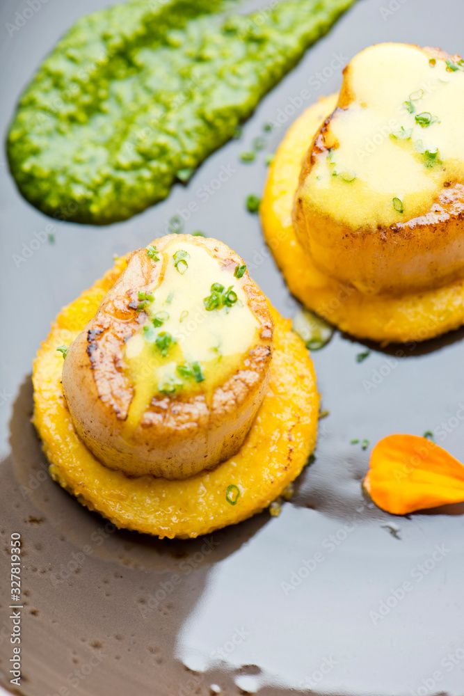 Scallops. Sea Scallops seared in brown butter sauce and garnished with a lemon sauce. Scallops. Sea Scallops seared in brown butter sauce and garnished with a lemon sauce.