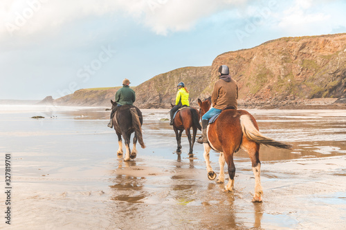 Horse ride on the beach in Wales at sunset