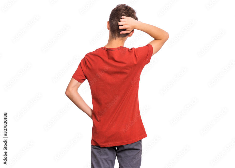 Back view. Teen boy thinking and looking to wall, isolated on white background. Thoughtful teenager in red - rear view. Confused child with his hands on head and waist. Back view. Teen boy thinking and looking to wall, isolated on white background. Thoughtful teenager in red - rear view. Confused child with his hands on head and waist.