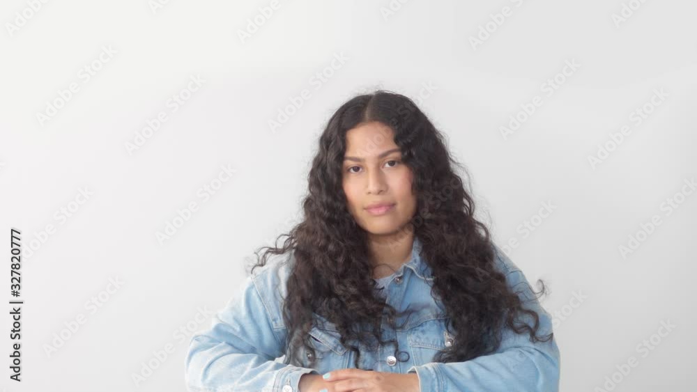 Slow motion portrait of native american mixed race plus size model in studio with hair blowing wears a jeans jacket urban style Slow motion portrait of native american mixed race plus size model in studio with hair blowing wears a jeans jacket urban style