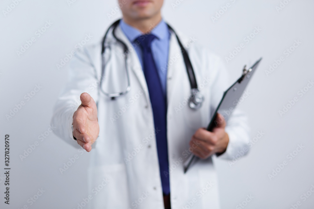 Friendly male doctor with open hand ready for hugging Friendly male doctor with open hand ready for hugging