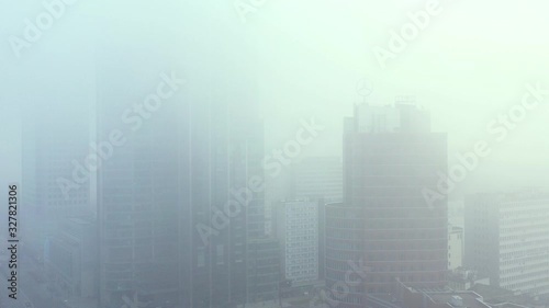 Drone footage of skyscrapers covered in clouds of smog in Warsaw city center