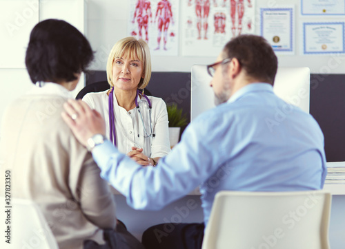 doctor talking to her male patient at office