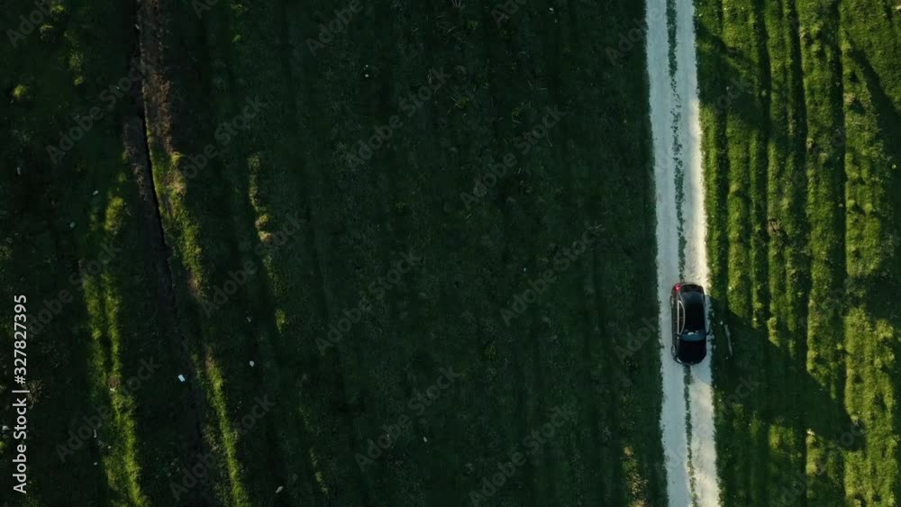 The car rides on the green field