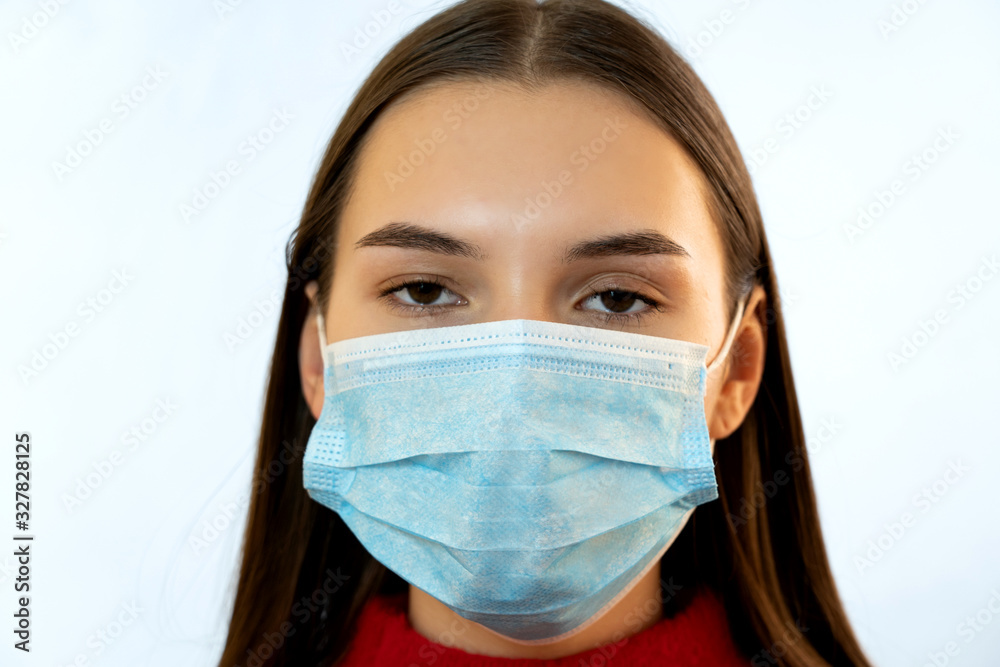 Sick young woman in medical mask.