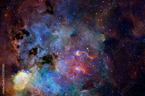 A beautiful nebula of different colors, with stars and galaxies. Elements of this image were furnished by NASA.