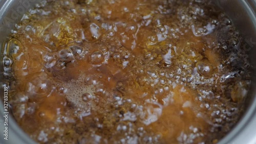 Detail slow motion shot batter-fried chicken meat nuggets are all deep fried well done in hot boiling oil pan