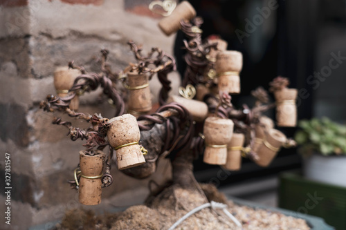Fototapeta Naklejka Na Ścianę i Meble -  Decorative tree plant on a pot made from used wine cork. Bonsai tree made from wine cork.