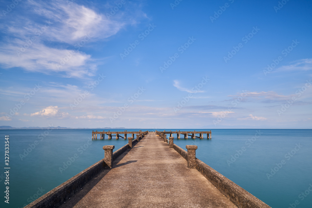 cement sea dock into ocean and blue sky with cloud