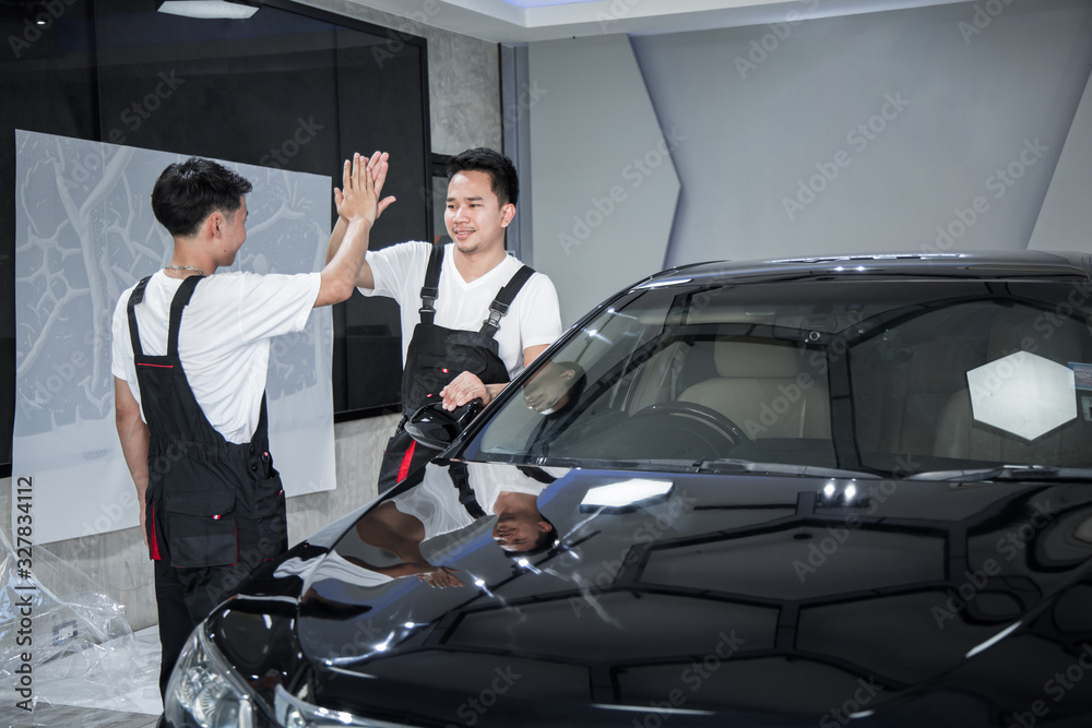 Success of two mechanic in shop transparent film, car paint protection. Success of two mechanic in shop transparent film, car paint protection.