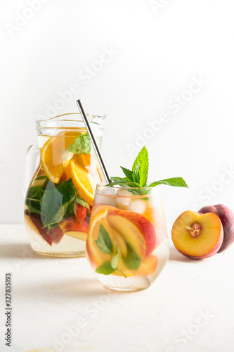 Detox peach beverage in glass garnish mint. Close up.