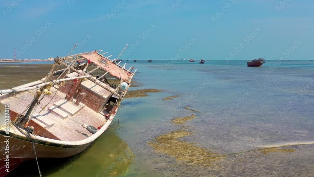 A boat stranded on a low tide beach. A boat stranded on a low tide beach.