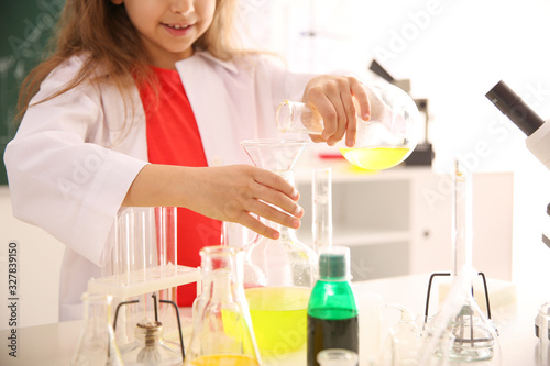 Schoolchild making experiment at table in chemistry class, closeup © New Africa