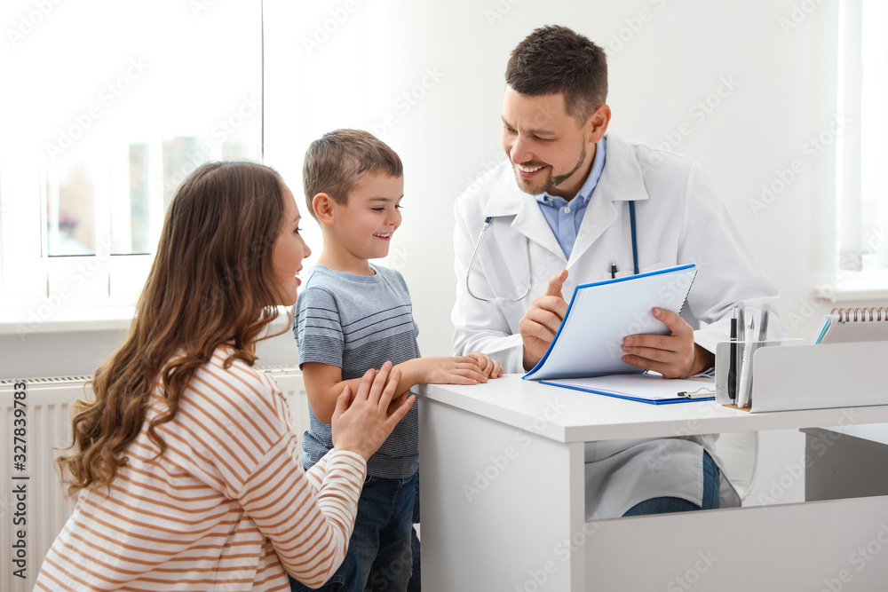 Mother and son visiting pediatrician. Doctor working with patient in hospital Mother and son visiting pediatrician. Doctor working with patient in hospital