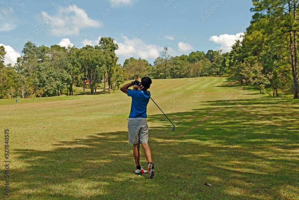 Golfer playing golf in beautiful golf course in the evening golf course Golfer playing golf in beautiful golf course in the evening golf course