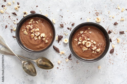 Chocolate smoothie with banana and nuts. Healthy eating. Top view with copy space.