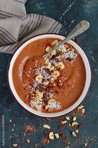 Chocolate smoothie with banana and nuts. Healthy eating. Top view with copy space.